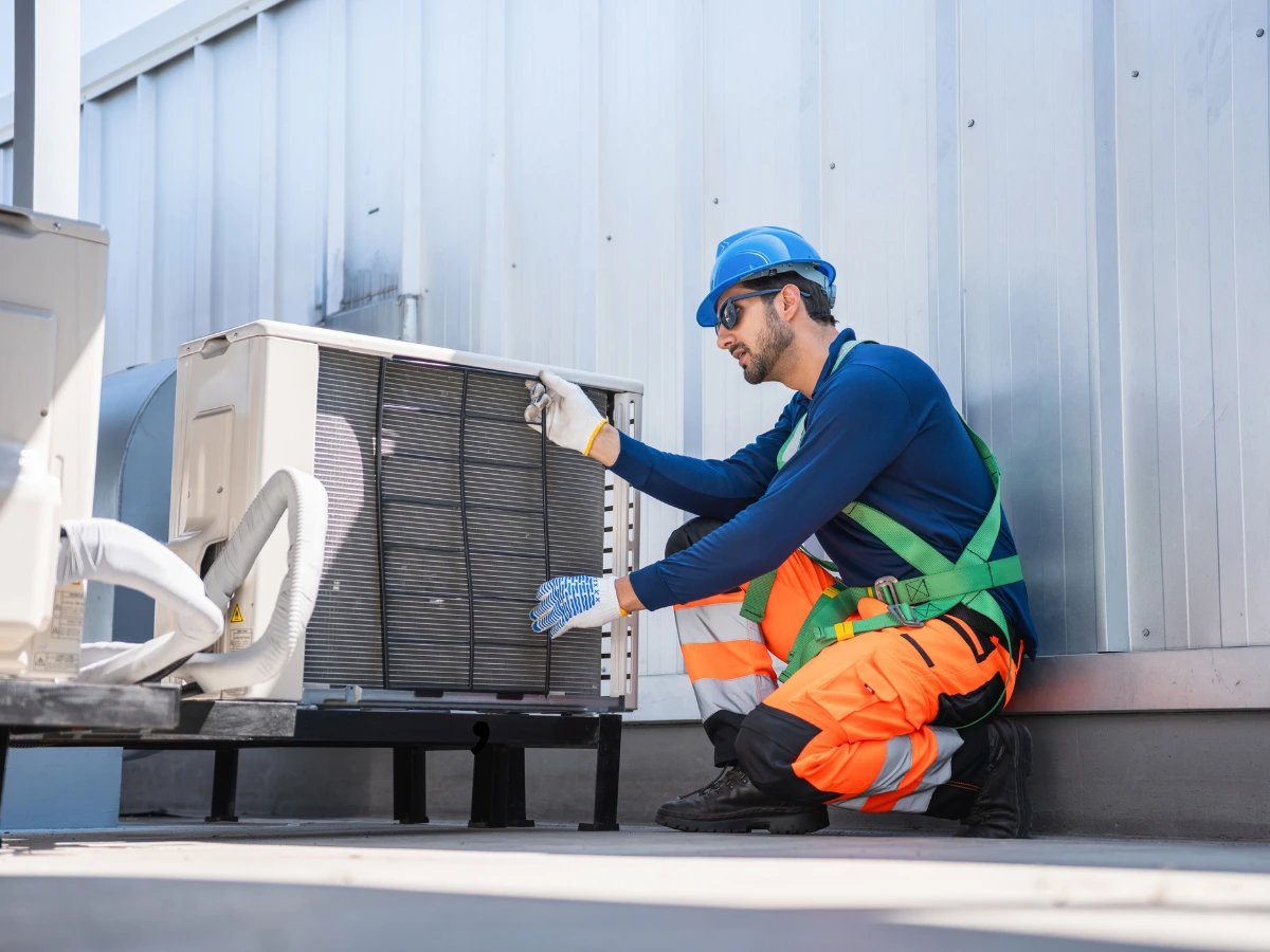 Professional technician carrying out AC maintenance in Dubai